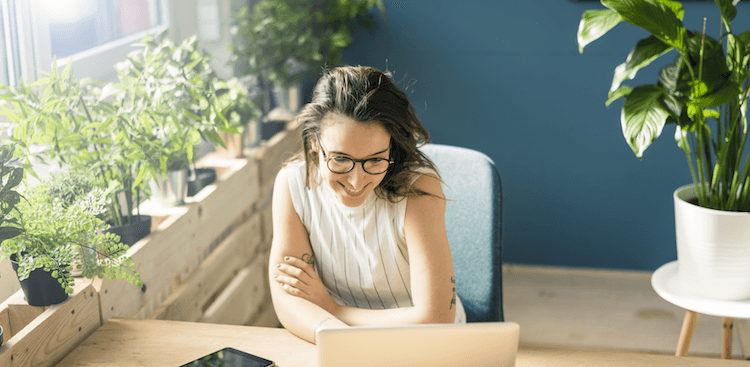 person sitting at a desk working on a laptop